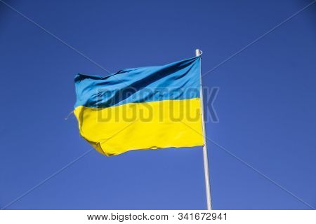 A Ukrainian Flag In The Blue Sky