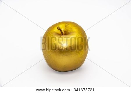 A Golden Apple On A White Background