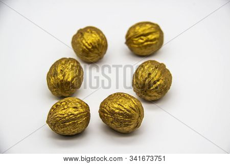 A Golden Walnuts On A White Background