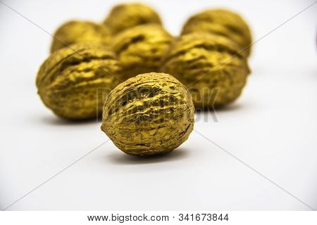 A Golden Walnuts On A White Background