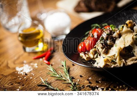 Black Angus pappardelle pasta with beef, champignon and parmegano cheese