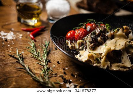 Black Angus pappardelle pasta with beef, champignon and parmegano cheese