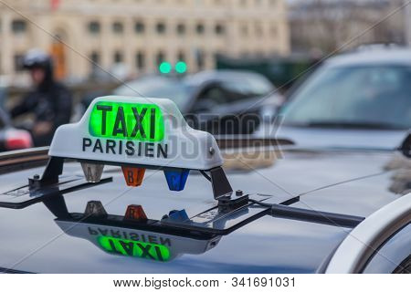 Paris Taxi sing on the roof of a transportation car in French Captial.