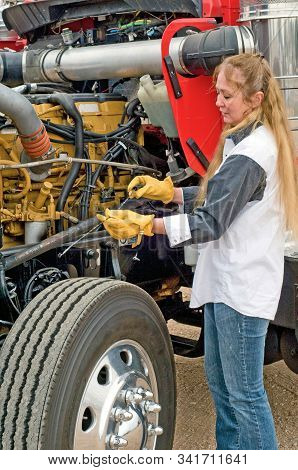 Driver Checking Oil And Pre-trip Inspection On A Big Truck.