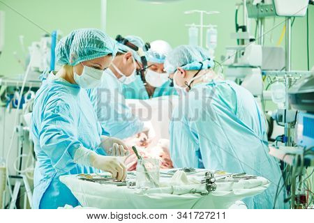 surgeons at work. female nurse at operation in child surgery hospital