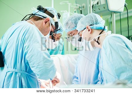 male cardiac surgeon at child cardiosurgery operating room