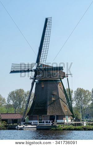 Waterways Of North Holland And View On Traditional Dutch Wind Mill, Dutch Lifestyle Landscape