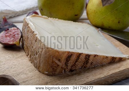 Piece Of French Cheese Tomme De Brebis Made From Sheep Milk Served As Dessert With Fresh Figs And Pe