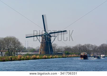 Waterways Of North Holland With Boats And View On Traditional Dutch Mill, Spring Landscape