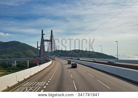 HONG KONG, CHINA - JUNE 18, 2015: view of the Kap Shui Mun Bridge seen from second desk of a double decker bus in Hong Kong in the daytime. 