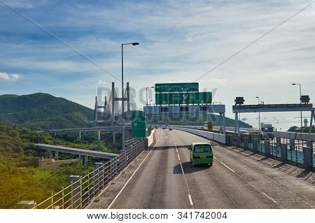 HONG KONG, CHINA - JUNE 18, 2015: view of the Kap Shui Mun Bridge seen from second desk of a double decker bus in Hong Kong in the daytime. 