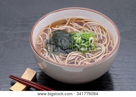 Japanese Kake Soba Noodles In A Ceramic Bowl On Black Background