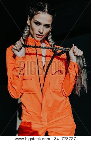 Woman With Colorful Braids In Working Clothes