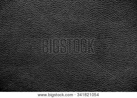 Black Genuine Leather. Dark Gray Background. Skin Structure Close Up.