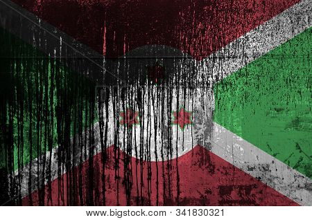 Burundi Flag Depicted In Paint Colors On Old And Dirty Oil Barrel Wall Closeup. Textured Banner On R