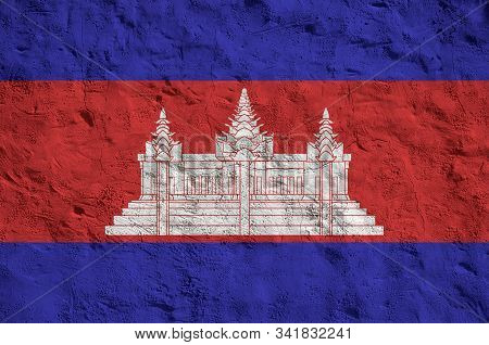 Cambodia Flag Depicted In Bright Paint Colors On Old Relief Plastering Wall. Textured Banner On Roug