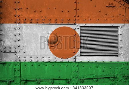 Niger Flag Depicted On Side Part Of Military Armored Tank Closeup. Army Forces Conceptual Background