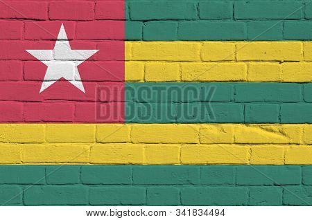 Togo Flag Depicted In Paint Colors On Old Brick Wall. Textured Banner On Big Brick Wall Masonry Back
