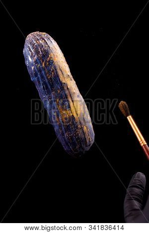 Beautiful Bright Eclair With Blets On A Dark Background.