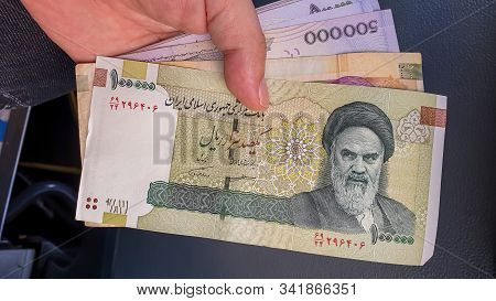 Hand Holding Iranian Rial. Rial Is The National Currency Of Iran