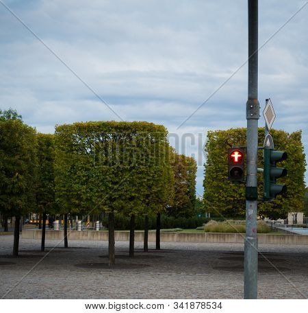 Nostalgic East German Traffic Light Ampelmaennchen With Cubic Trimmed Trees In Dresden, Germany. Sho