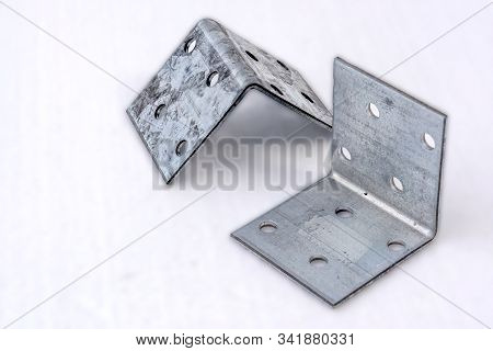 Metal Corners With Holes. Mounting Accessories On A White Background.