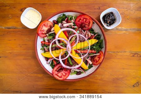 Peruvian Lomo Saltado, Consisted In A Beef And Different Fresh And Cooked Vegetables Served With Sal