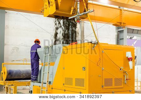 An Automatic Concrete Mixer Loads The Finished Mixture Into A Device For The Formation Of Hollow Cor