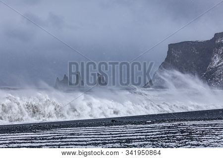 Storn On Atlantic Ocean. Breathtaking Morning View Of Reynisdrangar Cliffs. Impressive Winter Scene 