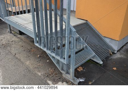 Supply Ramp In A Restaurant Or Shop. Galvanized Staircase With Railing And Ramp With Lattice Anti-sl