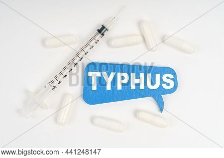 Medicine And Health Concept. On A White Background Pills, A Syringe And A Blue Plate With The Inscri