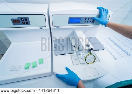 Laboratory Assistant Works At Paraffin Wax Dispenser Tissue Embedding Machine.