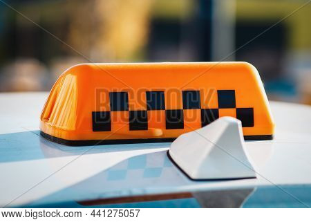 Checkered Taxi Sign On Top Of The Car Closeup