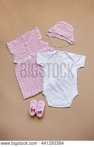 Girls Baby Bodysuit Mockup. Pink Crochet Baby Dress, Hat And Shoes And White. Diy Handmade Craft Cro