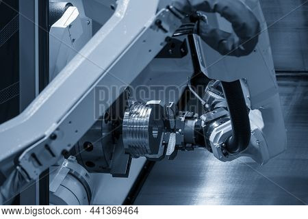 The Automatic  Robotic Arm Gripping The Metal Parts From Cnc Lathe Machine. The Hi-technology  Mater