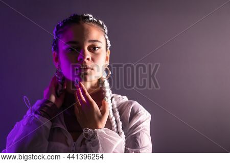 Urban Session. Portrait Of A Young Caucasian Woman With Long White Braids On A Plain Background, Rap