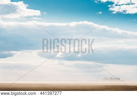 Belarus, Europe. Spring Dust Storm. A Dust Cloud From Agricultural Field Envelops Landscape.