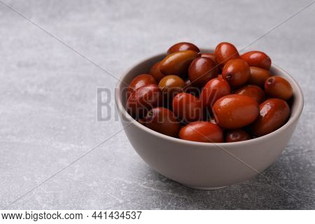 Fresh Ziziphus Jujuba Fruits In Bowl On Light Table. Space For Text