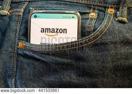 Madrid, Spain. 11-18-2021: Smartphone In The Front Pocket Of A Jean, On The Screen The Amazon App. E
