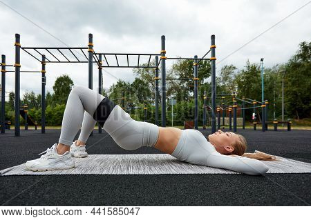 Resistance Band Fitness Outdoors. Young Athletic Woman With Perfect Body In Sportswear Doing Exercis