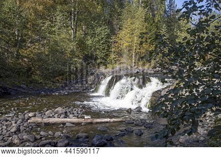 Autumn Landscape With A Waterfall On The Oster River In Karelia. The Forest Borders The Shores
