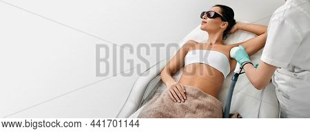 Woman During Underarm Laser Hair Removal And Armpit Laser Epilation At Beauty Center. Laser Epilatio