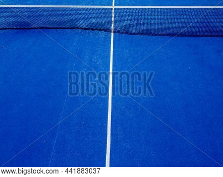 Partial View Of The Net And Half Of A Paddle Tennis Court