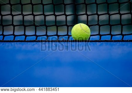 Selective Focus. A Ball Over The Net Of A Paddle Tennis Court