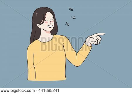 Smiling Laughing And Positive Emotions Concept. Young Girl Standing Pointing At Something And Laughi