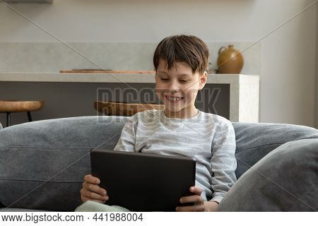 Happy Teenage Boy Using Digital Computer Tablet.