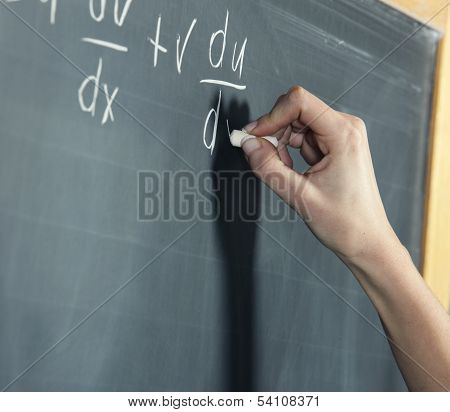 Close-up Of A Stunden's Hand Solving Maths Problem
