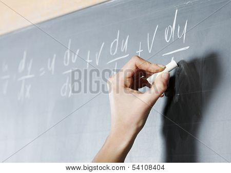 Close-up Of A Stunden's Hand Solving Maths Problem