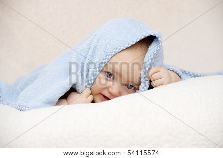 Baby Looking At The Camera On A Peach Background
