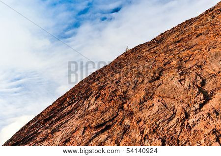 Rock Formation Against A Blue Cloudy Sky
